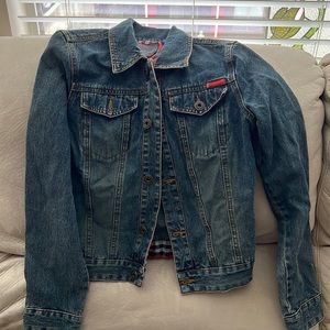 Jean jacket with buttons u front and on sides. Flannel material inside around.